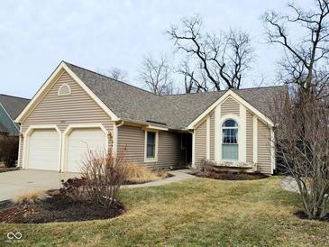 Charming single Gathering home featuring a two-car garage and manicured front lawn at 7682 Micawber Ct, Indianapolis, IN 46256