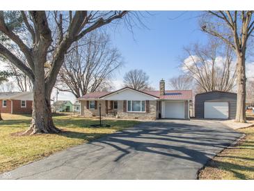 Charming single-story home features a stone facade, red metal roof, and mature trees in the front yard at 1780 S Mauxferry Rd, Franklin, IN 46131