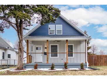 Charming renovated home featuring a covered porch with updated railings and a fresh blue and gray color scheme at 2626 E 18Th St, Indianapolis, IN 46218