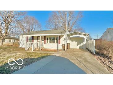 Cozy one-story home with a covered carport and well-maintained front yard at 283 N Brooks St, Columbus, IN 47201