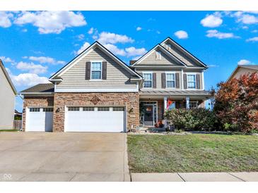 Charming two-story home with a manicured lawn, a two car garage, and a covered porch at 2912 Tuscarora Ln, Indianapolis, IN 46217