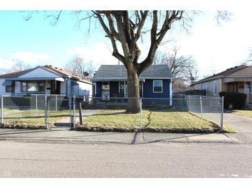 Charming single-story home with a fenced yard and inviting curb appeal on a sunny day at 4113 Fletcher Ave, Indianapolis, IN 46203