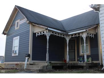 Charming home with a covered porch featuring decorative columns and gray siding at 416 Ketcham St, Indianapolis, IN 46222