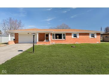 Charming single-story brick home with a well-manicured lawn, a driveway and a garage for convenient parking at 4812 Southview Dr, Anderson, IN 46013