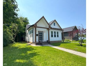 Charming home with craftsman-style architecture, lush lawn, and inviting curb appeal at 1818 N Cornell Ave, Indianapolis, IN 46202