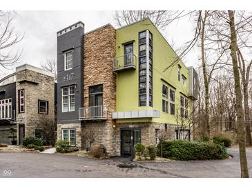 Stunning contemporary home with a unique facade, stone accents, and a modern color palette at 2417 E 80Th E St, Indianapolis, IN 46240