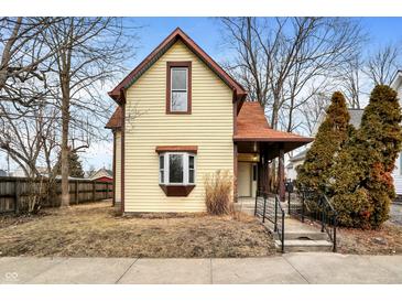 Charming two-story home with yellow siding, a red roof, and well-maintained landscaping at 462 W Broadway St, Greenwood, IN 46142