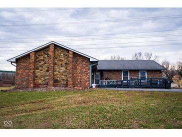 Charming single-story home featuring a blend of brick and stone, a ramp, and a well-maintained front lawn at 477 S Restin Rd, Greenwood, IN 46142