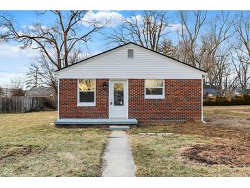 Charming brick home featuring a crisp white trim, a well-maintained walkway, and a cozy front yard at 6104 Gifford St, Indianapolis, IN 46228
