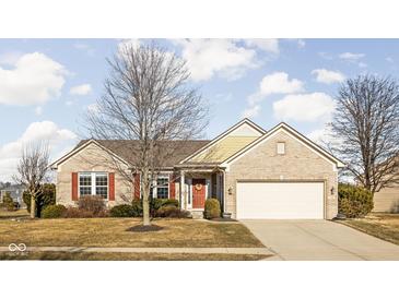 Charming brick home featuring a two-car garage and a welcoming front entrance with red shutters at 649 Hummingbird Dr, Brownsburg, IN 46112
