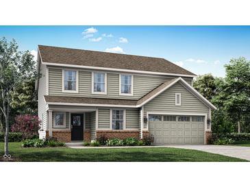Charming two-story home featuring a front-facing garage, landscaped yard, and classic curb appeal at 7225 Estes Dr, Indianapolis, IN 46239