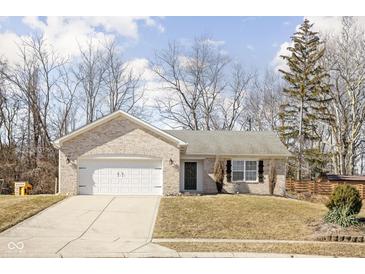 Charming single-story home featuring a well-maintained lawn, attached garage, and classic brick facade at 762 Courtney Cir, Danville, IN 46122