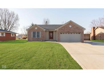Charming brick home with well-manicured lawn and a two-car garage at 1325 E 47Th St, Anderson, IN 46013