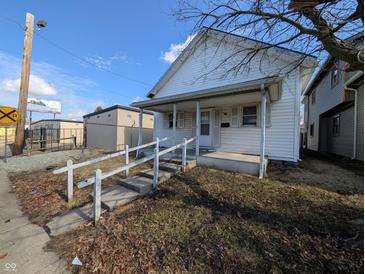 Charming exterior of a home featuring a quaint porch and classic design, perfect for a cozy lifestyle at 1610 Central Ave, Anderson, IN 46016