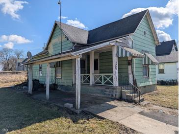 Vintage exterior showcases a porch with awning, and a traditional design, needs TLC at 1628 Sherman St, Anderson, IN 46016