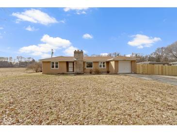 Charming single-story brick home with a well-maintained lawn and attached one car garage at 305 Bixler Rd, Indianapolis, IN 46227