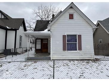 Quaint single-Gathering home with a snow-covered yard and classic architectural details at 317 S Harris Ave, Indianapolis, IN 46222