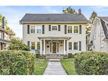 Charming two-story home featuring a covered porch, traditional windows, and a well-maintained front yard at 4305 Central Ave, Indianapolis, IN 46205