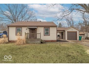 Charming single-story home with neutral siding, covered front porch, and detached garage at 4836 W 71St St, Indianapolis, IN 46268