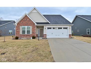Charming home with brick and siding, showcasing a two-car garage and well-maintained lawn at 5176 Green Valley Ln, Noblesville, IN 46062