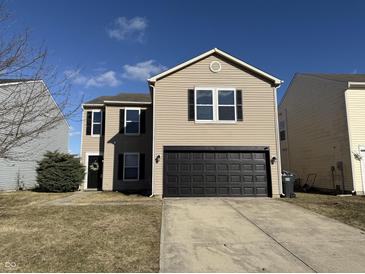 Charming two-story home with a well-kept lawn and a two-car garage, perfect for Gathering living at 8360 S Evening Dr, Pendleton, IN 46064