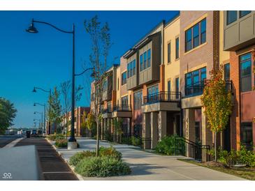 Charming street view showcasing modern townhomes with manicured landscaping and inviting curb appeal at 440 S Meridian Unit A-Bldg D St, Greenwood, IN 46142