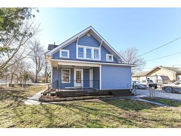 Charming blue home features a covered front porch and well-maintained lawn at 59 E Troy Ave, Indianapolis, IN 46225