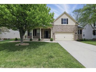 Attractive two-story house with a well-manicured lawn and a combination of brick and siding, plus an attached garage at 6126 Golden Eagle Dr, Zionsville, IN 46077