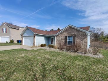 Charming single-Gathering home featuring a brick and siding exterior, attached garage and a well-manicured lawn at 1282 Highpointe Blvd, Shelbyville, IN 46176