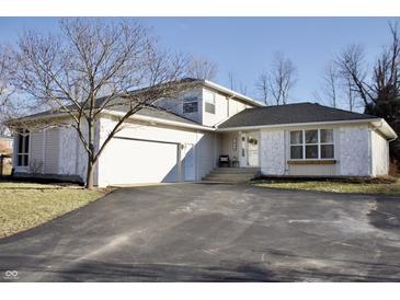 Charming single-Gathering home with a well-maintained lawn and attached garage at 1634 Muessing Rd, Indianapolis, IN 46239
