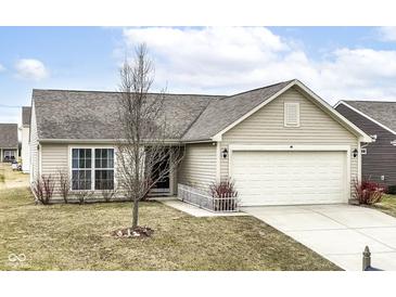 Charming single-story home featuring neutral siding, a two-car garage, and a well-maintained front yard at 4829 Penoyer Ln, Indianapolis, IN 46235