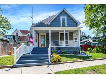 Charming two-story home featuring a welcoming front porch, beautiful landscaping, and gray exterior paint at 505 W Washington St, Shelbyville, IN 46176