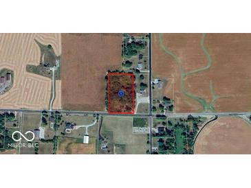 Aerial view of potential land to develop on surrounded by mature trees and accessible paved roads at 6944 E 300 S, Greenfield, IN 46140