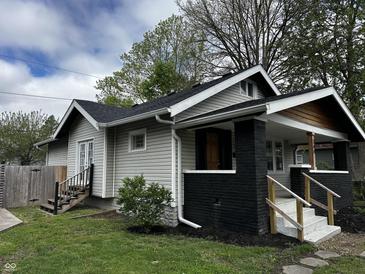 Charming home featuring gray siding, black brick accents, and a cozy front porch at 744 Wallace Ave, Indianapolis, IN 46201