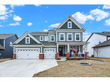 Charming two-story home featuring a three-car garage, a welcoming porch, and a well-maintained lawn at 16808 Audley Ave, Westfield, IN 46074