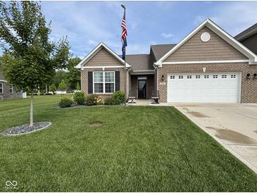 Well-maintained, single-story home with a lush front yard, brick facade, and attached two car garage at 1684 Hedley W Way, Avon, IN 46123