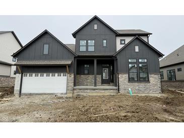 Modern two-story home with a dark gray exterior, stone accents, and a two-car garage at 19854 Chatham Shore Ln, Westfield, IN 46074