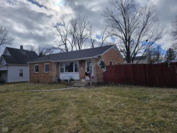 Charming brick ranch home featuring a well-maintained lawn and inviting front porch at 2113 Silver St, Anderson, IN 46012