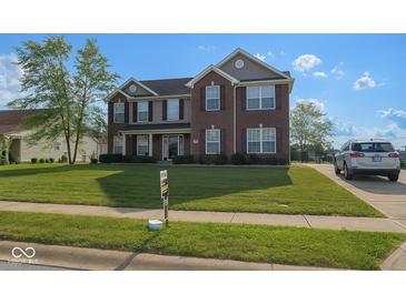Charming two-story home boasts a manicured lawn, brick facade, and well-maintained landscaping at 254 Halldale Dr, Whiteland, IN 46184