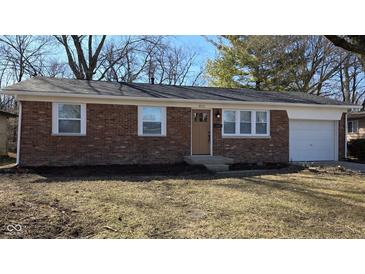 Charming brick home featuring updated windows and a well-maintained front yard at 4713 Calhoun St, Indianapolis, IN 46203