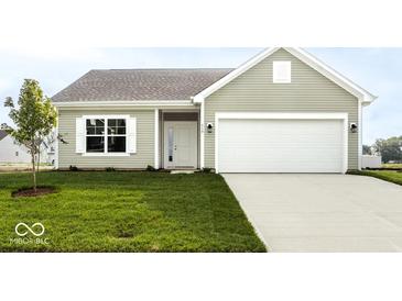 Charming single-story home boasts a well-manicured lawn, attached garage, and neutral siding at 632 Derek Ln, Trafalgar, IN 46181