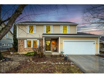 Charming two-story home featuring neutral siding, brick accents, and a two-car garage at 6440 Watercrest Way, Indianapolis, IN 46278