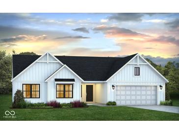 Charming single-story home with white siding, a black roof, and an attached two car garage at 651 Rylan Cir, Greenwood, IN 46142