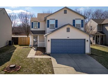 Two-story home with blue shutters, a large blue garage door, and a well-maintained lawn at 10725 Chenille Ct, Indianapolis, IN 46235