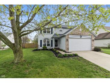 Charming two-story home featuring blue shutters, a well-manicured lawn, and an attached two-car garage at 14055 Mimosa Ct, Fishers, IN 46038