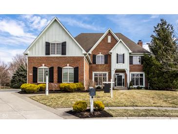 Beautiful brick home with a manicured lawn and a classic architectural style at 1805 Braeburn Dr, Carmel, IN 46032