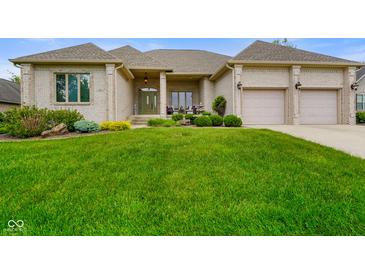 Well-manicured front lawn and exterior of home with 3-car garage and mature landscaping at 286 S Woodridge Dr, Pittsboro, IN 46167