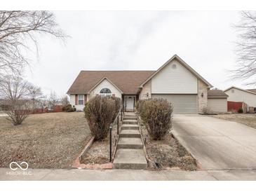 Charming home with a brick and siding exterior, landscaped front yard, and inviting entryway steps at 2888 Prairie Stream Way, Columbus, IN 47203