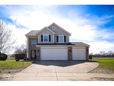 Charming two-story home featuring a spacious three-car garage and well-maintained front yard at 7136 Allegan Dr, Indianapolis, IN 46217