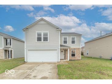 Charming two-story home featuring a front-facing garage and a neatly maintained lawn at 8444 Ash Grove Dr, Camby, IN 46113